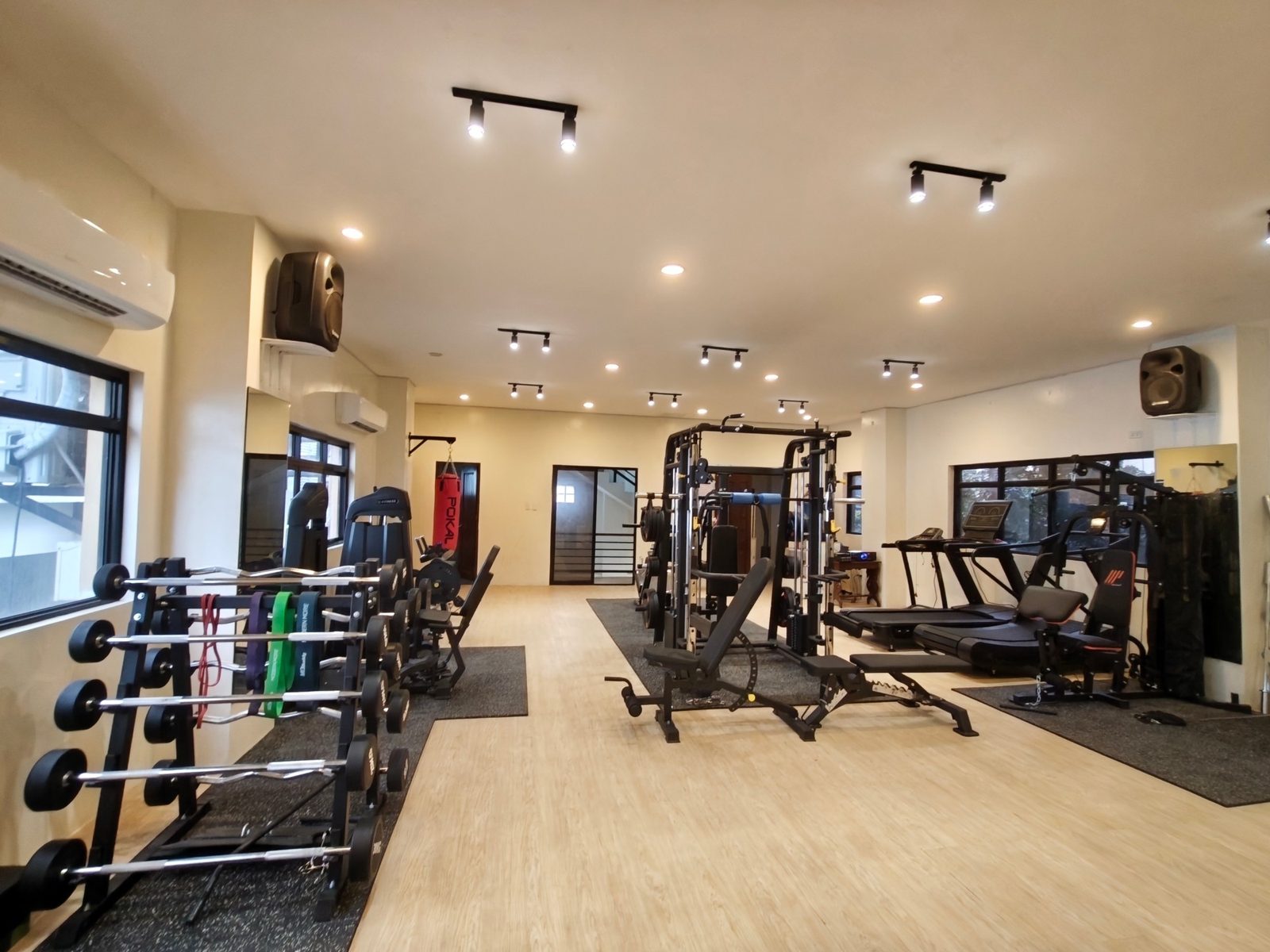Barbell rack and resistance bands next to the windows